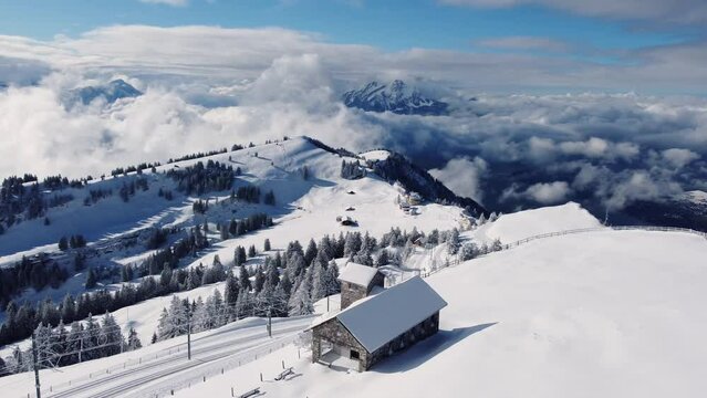 Rigi, Switzerland: Aerial drone footage of the summit of the Rigi mountain with snow in winter in the Swiss alps in Canton Lucerne. 