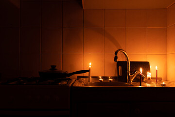 Apartment without electricity, kitchen by candlelight, Ukraine without electricity due to the war, in the dark 2022