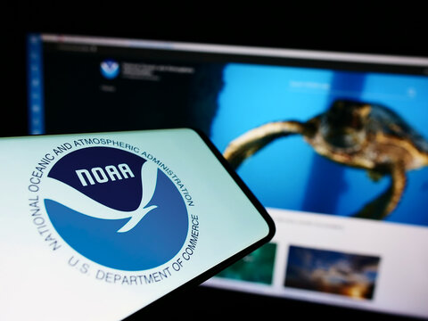 Stuttgart, Germany - 10-09-2022: Cellphone with logo of National Oceanic and Atmospheric Administration (NOAA) on screen with website. Focus on center-right of phone display.