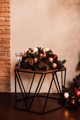 Wooden table decorated with Christmas decor with cones and Christmas balls