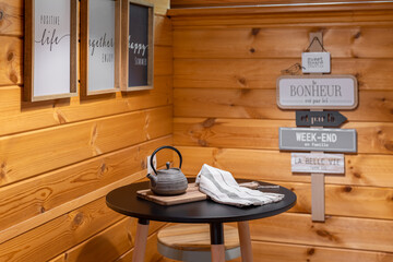 A small table with an Asian teapot in the cottage's wooden kitchen. Village life concept.