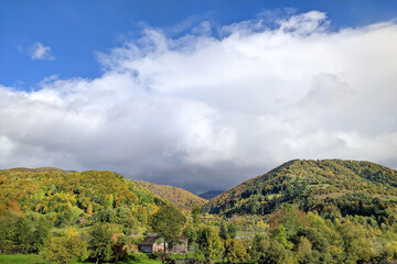 Beautiful landscape. Fluffy clouds over mountains at sunny day.