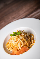 Recipe for homemade spaghetti with tomato sauce, smoked salmon, roasted peanuts and parmesan. High quality photo