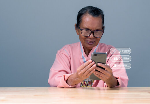 Asia woman old, senior, person smile and happy holding smartphone with online connection to internet for using looking report healthy. Woman using smartphone for contect with doctor check health care
