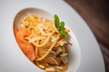 Recipe for homemade spaghetti with tomato sauce, smoked salmon, roasted peanuts and parmesan. High quality photo