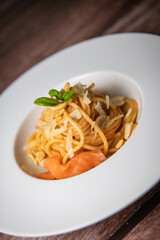 Recipe for homemade spaghetti with tomato sauce, smoked salmon, roasted peanuts and parmesan. High quality photo