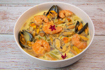 Recipe for marinated mussels with fresh cream, saffron curry and prawns. High quality photo