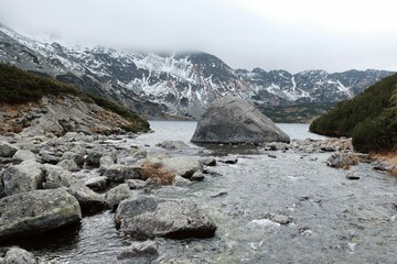 Valley of Five Polish Ponds in Polish High tatras most beautiful Place on earth. Big boulder in water. Karpaty, Poland