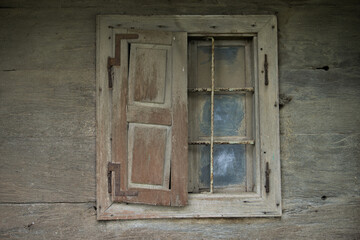 Obraz na płótnie Canvas Croatia, October 20,2022 : Rustic style aged window at rural home wall. 