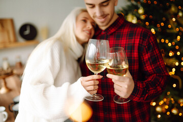 Love story young couple in winter. Enjoying spending time together in New Year Eve at home. Romantic day. Winter holidays.