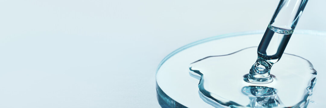 Pipette with sample of cosmetic product in petri dish on blue banner, selective focus