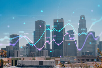 Los Angeles panorama skyline of downtown at day time, California, USA. Skyscrapers of LA city. Glowing forex graph hologram. The concept of internet trading, brokerage and fundamental analysis