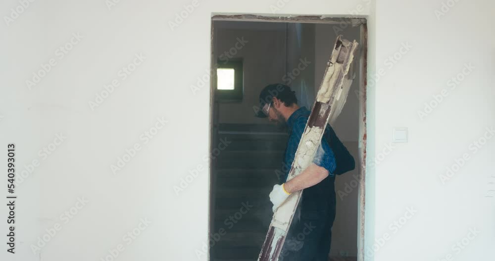 Wall mural Construction handyman works on apartment renovation demolishes door frames, total demolition of house.