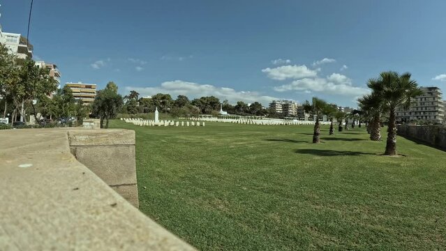 Time lapse video shows a part of the Commonwealth War Cemetery located at Palaio Faliro-Athens. Blue sky and clouds at the background.