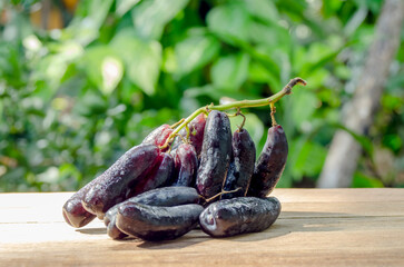 bunch of witch finger grapes on wooden floor