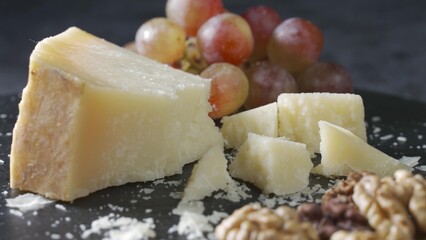 Cheese plate close-up with several varieties of fruit and cheese