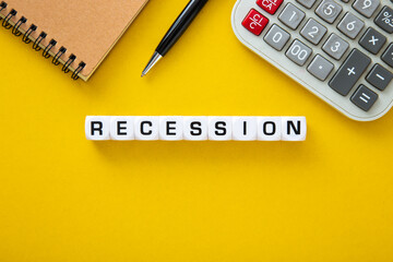 Recessios word on yellow background. Downturn Economy Concept