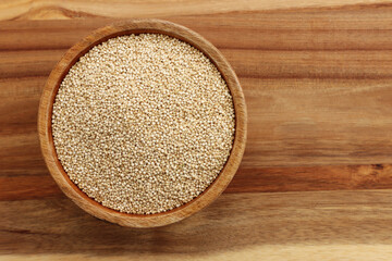 Top view image of quinoa in wooden plate on table