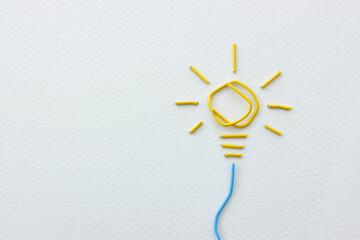 Concept image of unique thinking. Paper clips in the shape of light bulb. Idea of education and...