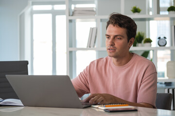 Young man student on a video conference, talking in office room