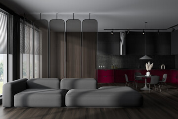 Dark studio interior with soft place and kitchen area, panoramic window