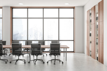 White conference room interior with board and armchairs near panoramic window