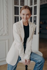 Trendy stylish businesswoman. Portrait of young adult european woman in white jacket.