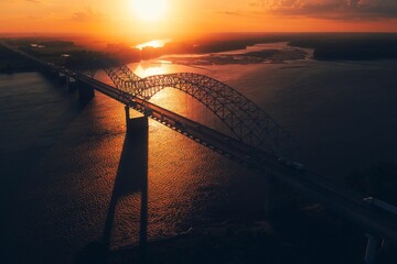 Bird's eye view of Memphis Bridge connecting Tennessee and Arkansas at sunset over Mississippi River