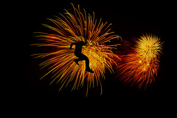 silhouette man  jumping Abstract Freworks fireworks in the night sky stock Image In Black Background