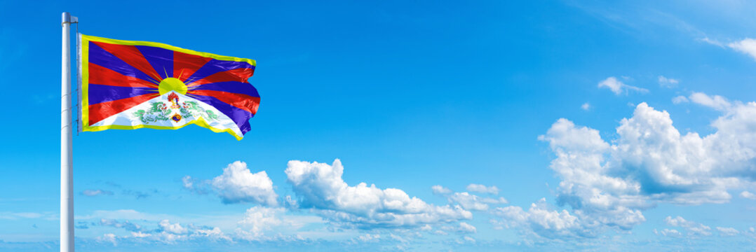 Tibet, flag waving on a blue sky in beautiful clouds - Horizontal banner