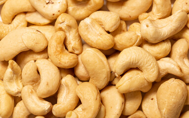 Cashew nuts as a background, top view. Cashew isolated on white background. Healthy foods.