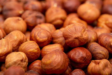 Heap of hazelnuts close-up. Peeled nuts. Hazelnut isolated on white background.