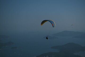 Paragliding in the dark blue evening sky