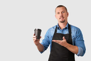 Young man barista portrait on white background with copy space