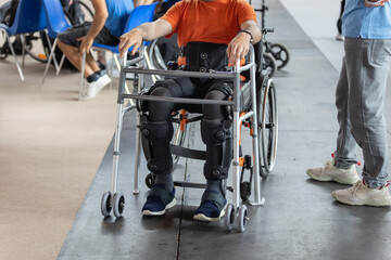 Boy with Mobility Problems in Lower Limbs Sitting in a His Wheelchair Ready to Stand Upright Thanks...