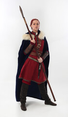 full length portrait of beautiful woman wearing a red medieval fantasy warrior costume with leather...