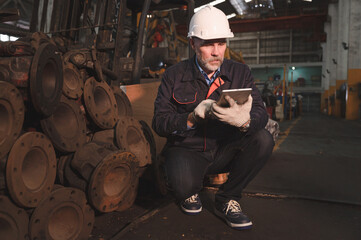 Engineer use tablet checking spares in factory spares train 