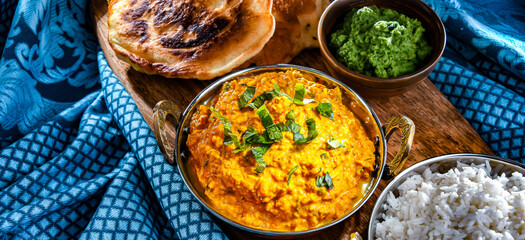 Curry chicken with rice served in original indian karahi pots