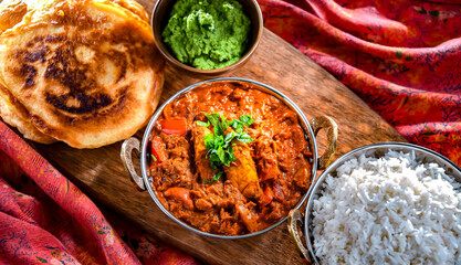 Butter chicken with rice and naan bread served in karahi pots