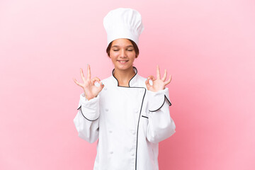 Little caucasian chef girl isolated on pink background in zen pose