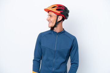Young cyclist caucasian man isolated on white background looking side