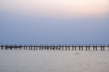 Fototapeta premium long wooden pier on the beach