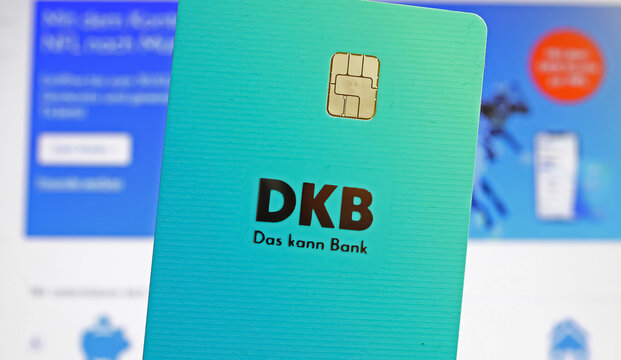 Viersen, Germany - October 9. 2022: Closeup of DKB Deutsche Kredit Bank EC debit card, blurred online shop website background