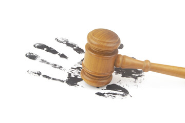 Crimes investigation and court concept. Wooden judge gavel on black handprint on white background.