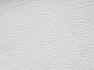 White leather texture sample. Background with copy space, top view. Genuine leather closeup in light white tone. Backdrop textured effect for design, upholstered furniture, clothing. Faux eco leather.