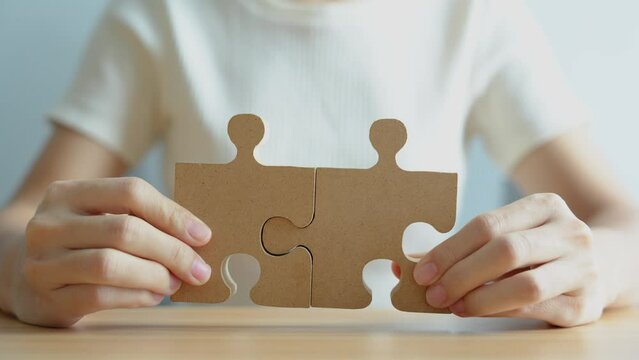 Hand connecting couple puzzle piece. Business Solving, mission, challenge, success, goals, target and strategy concepts