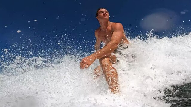 POV extreme man surfing blue ocean wave 