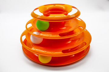 Orange and round shape plastic cat toy with white background.  Plastic pet toy.