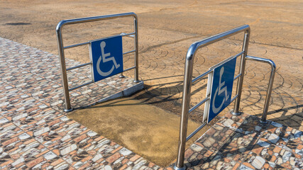 Disabled way sign in front of building. Handicapped sign traffic symbol on the floor in front of...