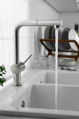 Stream of water flowing from tap in kitchen